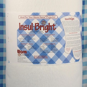 May include: A roll of Insul-Bright, a needled insulated lining material. The packaging features a blue and white checkered pattern and lists project ideas like oven mitts and covers. The text reads "Ideal For Your Warm Home Projects!"