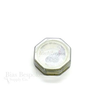 May include: A clear, octagonal tape measure case with a white tape inside. The tape measure is marked with both inches and centimeters. The text "made in germany" and "hoechstmass" are visible on the tape measure case.