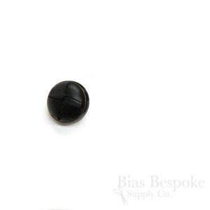 May include: A black leather button with a woven design. The button has a gold rim.