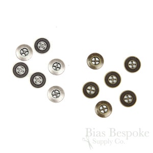 May include: A collection of 10 metal buttons, 5 silver and 5 bronze, with a cross design in the center. The buttons have a textured edge.