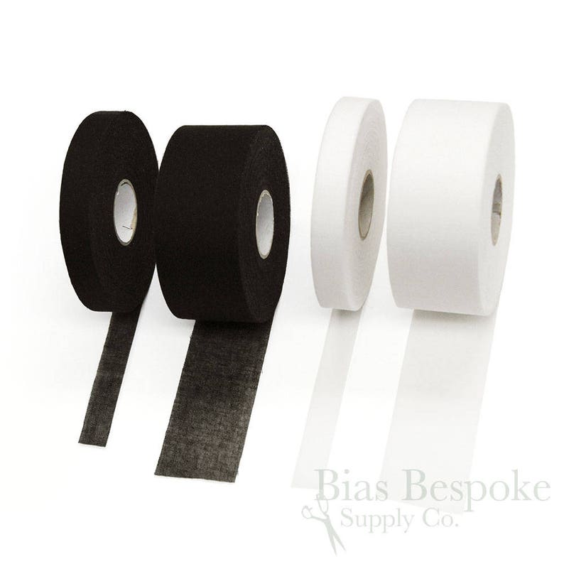 May include: Two rolls of black fusible interfacing and two rolls of white fusible interfacing. The interfacing is a woven fabric used to stiffen and stabilize fabric.