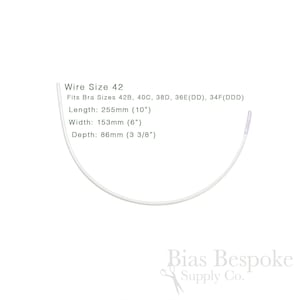 May include: A white bra underwire, size 42, with measurements: 255mm long, 153mm wide, and 86mm deep. The image text indicates the wire fits bra sizes 42B, 40C, 38D, 36E(DD), and 34F(DDD).