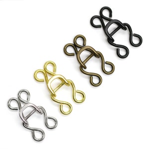 May include: Four metal hook and eye closures in different finishes: silver, gold, bronze, and black.