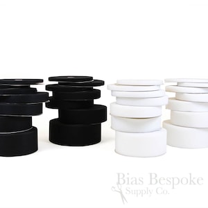 May include: Stacks of black and white hook and loop tape, also known as sew-on velcro, for sewing projects. Bias Bespoke Supply Co. is printed below the stacks.