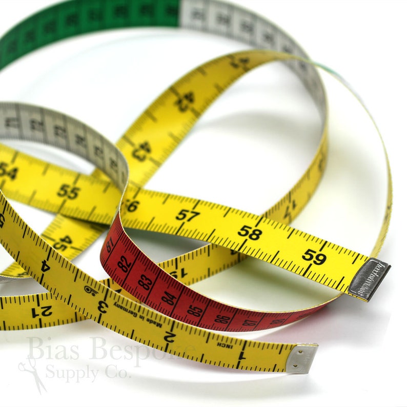 May include: A collection of colorful measuring tapes, including yellow, red, green, and white. The tapes are marked with inch and centimeter measurements, ideal for sewing and crafting projects. The image shows the tapes in a close-up shot.