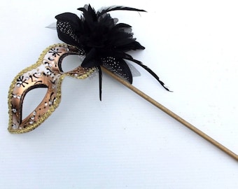 Stunning Black and Gold Flower Masquerade Mask on a Gold Stick