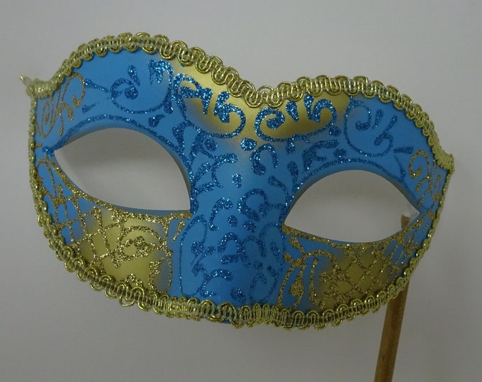 Turquoise Blue and Gold Masquerade Mask Hand Held on a Wooden Stick