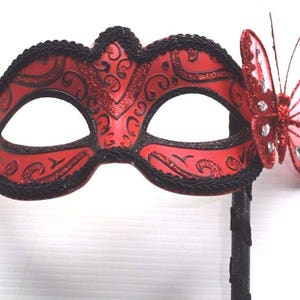 Red and Black Butterfly Masquerade Mask on a Black Stick