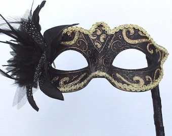 Gold and Black Masquerade Mask on a Black Stick with Flower