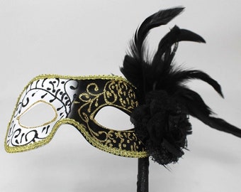 Black and Gold Masquerade Mask on a Stick with Feather Detail