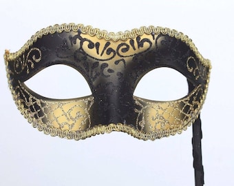 Glittering Black and Gold Masquerade Mask on a Black Stick