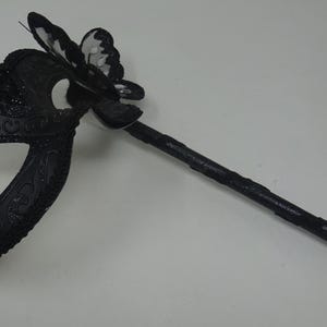 Black Venetian Masquerade Ball Party Carnival Mask with Black Butterfly Details on a Hand Held Stick