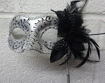 Stunning Black and Silver Feather Masquerade Mask with a Flower & Feathers on a Silver Stick
