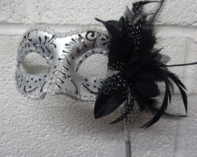 Stunning Black and Silver Feather Masquerade Mask with a Flower & Feathers on a Silver Stick