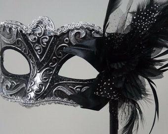 Stunning Black and Silver Masquerade Mask on a Black Stick with Flower