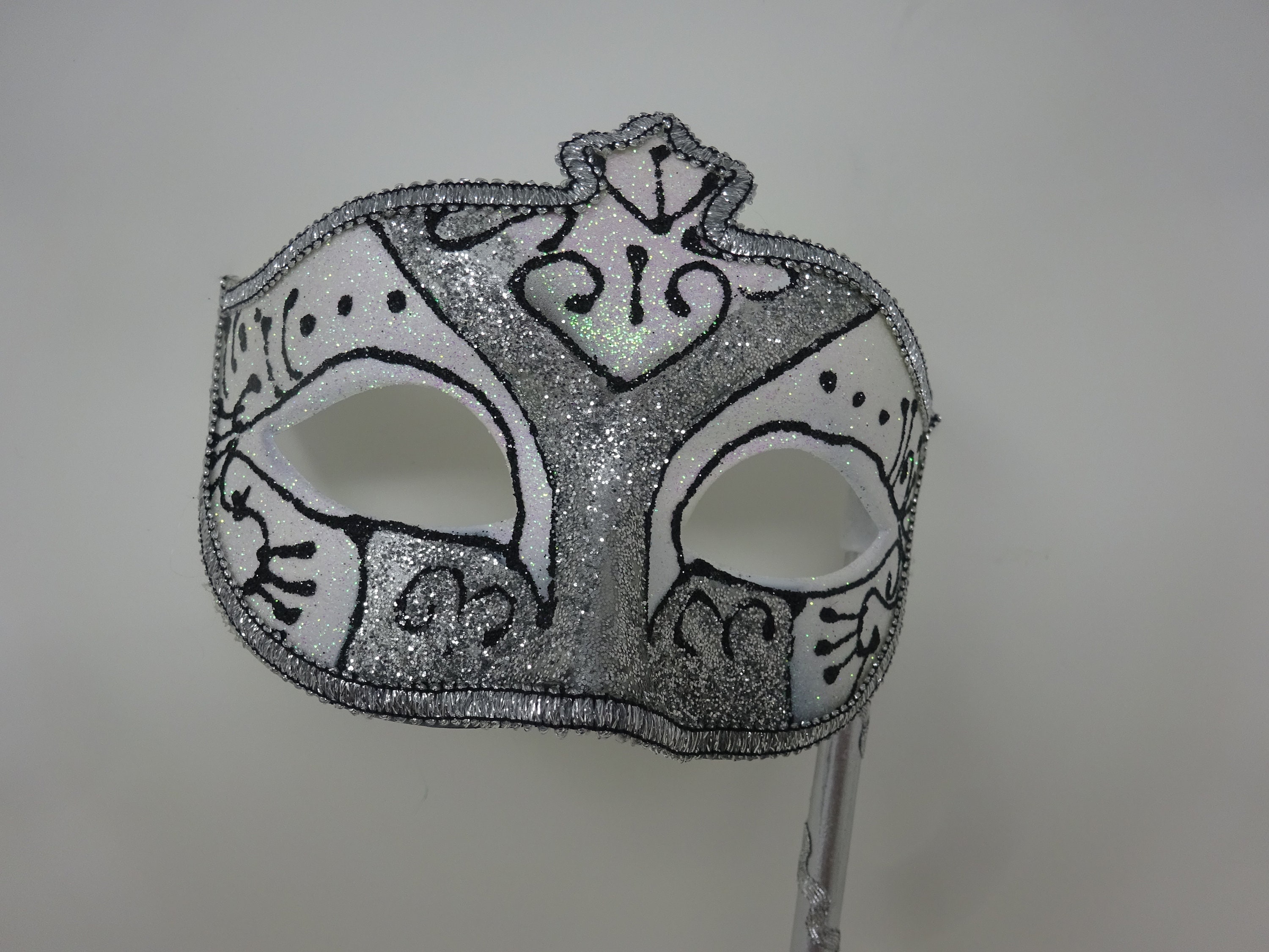 Black Frosted White and Silver Glitter Mask Hand Held on a