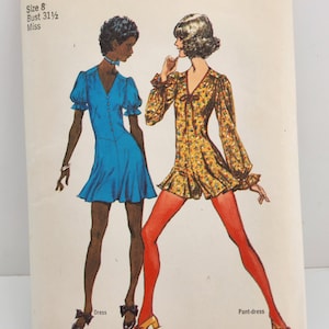 May include: Vintage Simplicity sewing pattern number 9781 for a dress and pant-dress. The pattern is for size 8, bust 31 1/2 inches, and is for a miss. The pattern shows two women wearing the dress and pant-dress. The dress is blue and the pant-dress is yellow with a floral print.