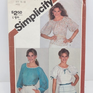 May include: A vintage Simplicity sewing pattern envelope. The envelope features images of three different blouses. The text on the envelope includes "Simplicity", "5376", "Small Size 10-12 Miss", and "Overnight Success".