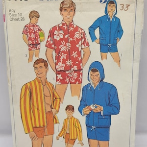 May include: Vintage Simplicity sewing pattern for boys' clothing, featuring illustrations of various outfits. The pattern includes a red floral shirt and shorts set, a blue hooded jacket and shorts, and a yellow and orange striped jacket and shorts set.