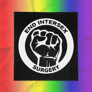 May include: A square black fabric patch featuring a white circular border with the text END INTERSEX SURGERY printed in bold capital letters. In the center of the circle is a white graphic illustration of a raised fist, symbolizing activism.