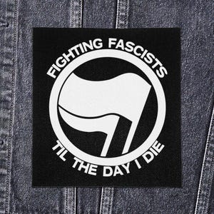 May include: Black square patch with a white circular design and text. The design features a stylized flag within a circle, with the words "FIGHTING FASCISTS" at the top and "TIL THE DAY I DIE" at the bottom, all in white lettering.