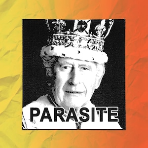 May include: A square black and white fabric patch featuring a high-contrast graphic of a person wearing a crown. The word PARASITE is printed in bold white capital letters at the bottom of the patch, centered below the portrait illustration.