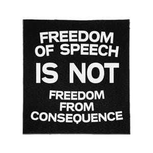 May include: A square black fabric patch featuring bold white text that reads: FREEDOM OF SPEECH IS NOT FREEDOM FROM CONSEQUENCE. The lettering is arranged in five lines with a clean, sans-serif font style against the dark, textured background.