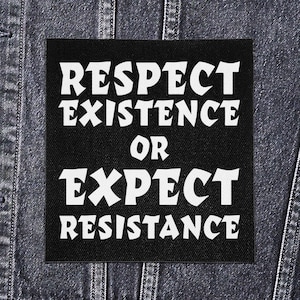 May include: A black square patch with white text, reading "RESPECT EXISTENCE OR EXPECT RESISTANCE." The patch is displayed on a denim jacket. The text is in a bold, stylized font.