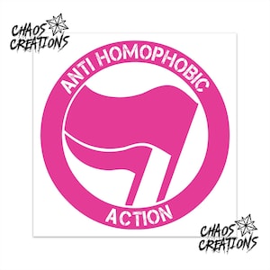 May include: A circular sticker featuring a bright pink flag icon centred within a pink ring. The text ANTI HOMOPHOBIC is arched across the top and ACTION is at the bottom in a distressed white font. The logo CHAOS CREATIONS appears in the corners.