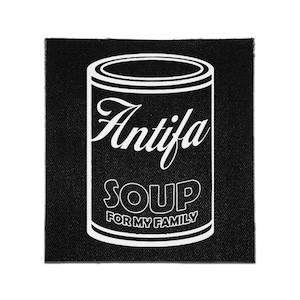 May include: A square black fabric patch featuring a white line art illustration of a soup can. The text Antifa is written in a cursive script above the word SOUP in bold block letters, with the phrase FOR MY FAMILY printed below in smaller text.