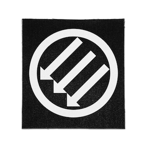 Könnte beinhalten: Ein quadratischer Stoffaufnäher mit schwarzem Hintergrund und weißem kreisförmigem Rand. Innerhalb des Kreises zeigen drei parallele weiße Pfeile diagonal nach unten links und sind in einer treppenartigen Anordnung platziert.
