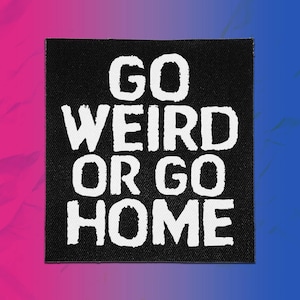 May include: A square black fabric patch featuring the white text "GO WEIRD OR GO HOME" in a bold, sans-serif font. The lettering has a slightly distressed, textured appearance against the solid black background of the patch material.