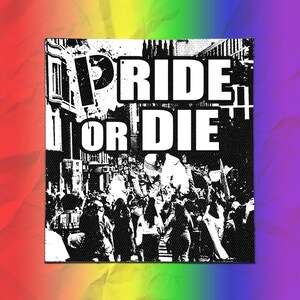 May include: A square fabric patch featuring a high-contrast black and white graphic of a crowd at a protest. The bold text PRIDE OR DIE is printed in white across the top center. The background behind the patch is a vibrant rainbow gradient.
