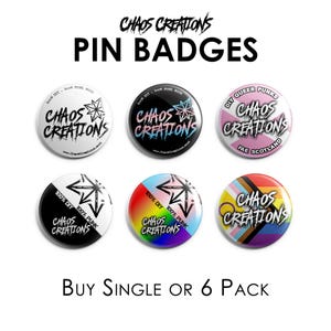 May include: A collection of pin badges with the text "CHAOS CREATIONS" in a variety of colors and designs. Some badges include additional text such as "DIY QUEER PUNKS" and "FAE SCOTLAND". The badges are round and have a glossy finish.