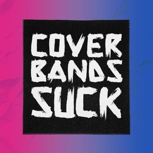 May include: A square black fabric patch featuring the white text COVER BANDS SUCK in a distressed, brush-stroke style font. The lettering is arranged in three lines, with the words stacked vertically against the solid black background.