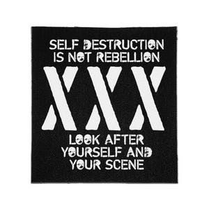 May include: A square black fabric patch featuring white distressed-style text that reads SELF DESTRUCTION IS NOT REBELLION, followed by three large white X symbols, and the text LOOK AFTER YOURSELF AND YOUR SCENE at the bottom.