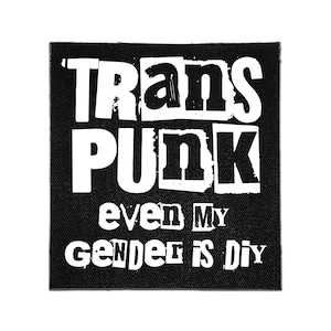 May include: A square black fabric patch featuring white screen-printed text that reads TRANS PUNK in a bold, distressed font, followed by the text even MY GENDER is DIY in a smaller, mixed-case, distressed typeface.