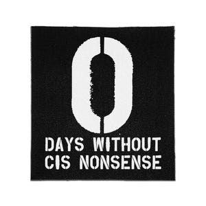 May include: A square black fabric patch featuring a large white stencil-style number zero at the top. Below the number, the text reads "DAYS WITHOUT CIS NONSENSE" in a matching white, distressed, stencil-style font against the black background.