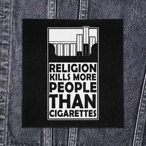 May include: Black square patch with white text and a graphic of a cigarette pack and cigarettes. The text reads "RELIGION KILLS MORE PEOPLE THAN CIGARETTES." The patch is displayed on a denim jacket.