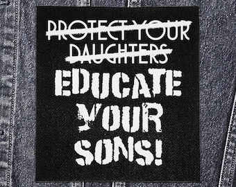 May include: Black square patch with white text that reads "PROTECT YOUR DAUGHTERS" with the words crossed out, followed by "EDUCATE YOUR SONS!". The patch is set against a denim jacket.