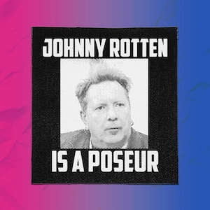 May include: A square black fabric patch featuring a white halftone portrait of a person in the center. The text JOHNNY ROTTEN is printed in white capital letters above the portrait, and the text IS A POSEUR is printed in white below it.