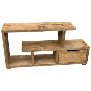 May include: A rustic wooden TV stand with a shelf and a drawer. The stand is made of reclaimed wood and has a natural finish.