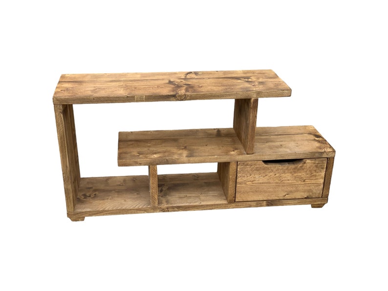 May include: A rustic wooden TV stand with a shelf and a drawer. The stand is made of reclaimed wood and has a natural finish.