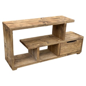 May include: Rustic wooden TV stand with open shelves and a drawer. The stand is made of reclaimed wood and has a natural finish.