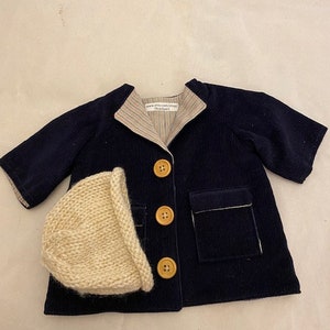 Navy blue corduroy barn jacket with striped lining and hand knit hat that fits 18in American Girl doll