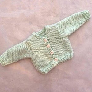 Light green handknit cardigan sweater that fits 18 inch dolls
