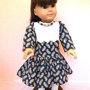Long sleeve navy blue paisley school dress with eyelet overlay and sewn on necklace that fits 18&quot; American Girl dolls