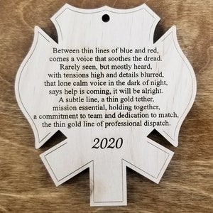 May include: A wooden ornament shaped like a firefighter's badge with the year 2020 and a poem about the thin gold line of professional dispatch.