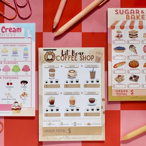 May include: Three illustrated menu cards for an ice cream shoppe, coffee shop, and bakery. The ice cream menu features ice cream flavors and toppings. The coffee shop menu lists coffee drinks. The bakery menu displays baked goods.