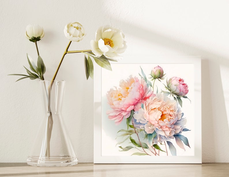 Pode incluir: Uma moldura branca com uma pintura em aquarela de pe&ocirc;nias rosa e brancas com folhas verdes. A pintura est&aacute; sobre um fundo branco.